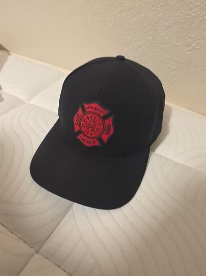 Black leather patch hat with red fire department crest patch on angled view